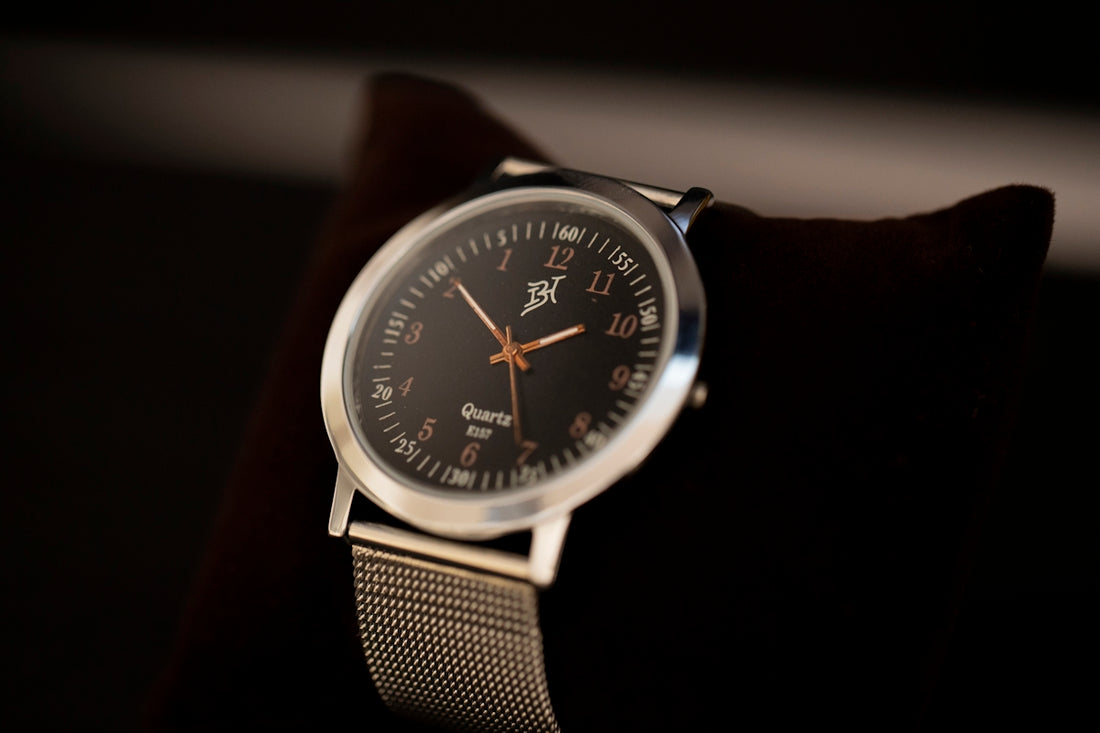silver and black round analog watch