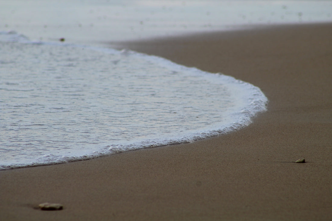 white sand near body of water during daytime