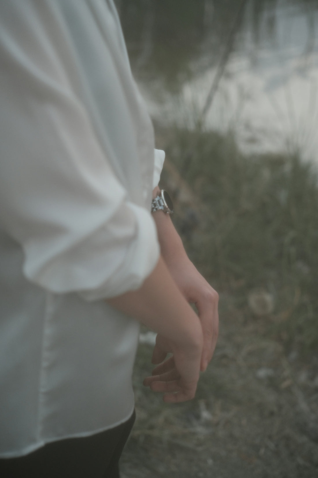 a person wearing a white shirt and a watch