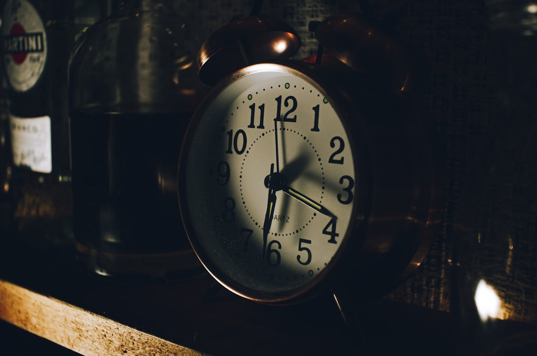 a close up of a clock on a shelf