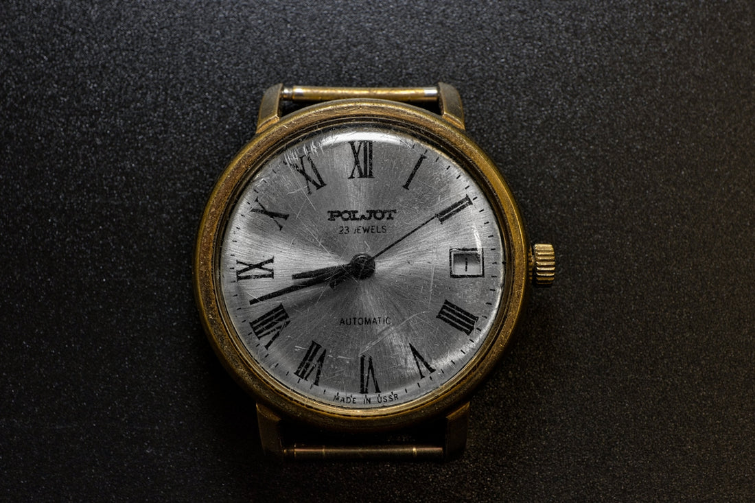 A close up of a watch on a black surface