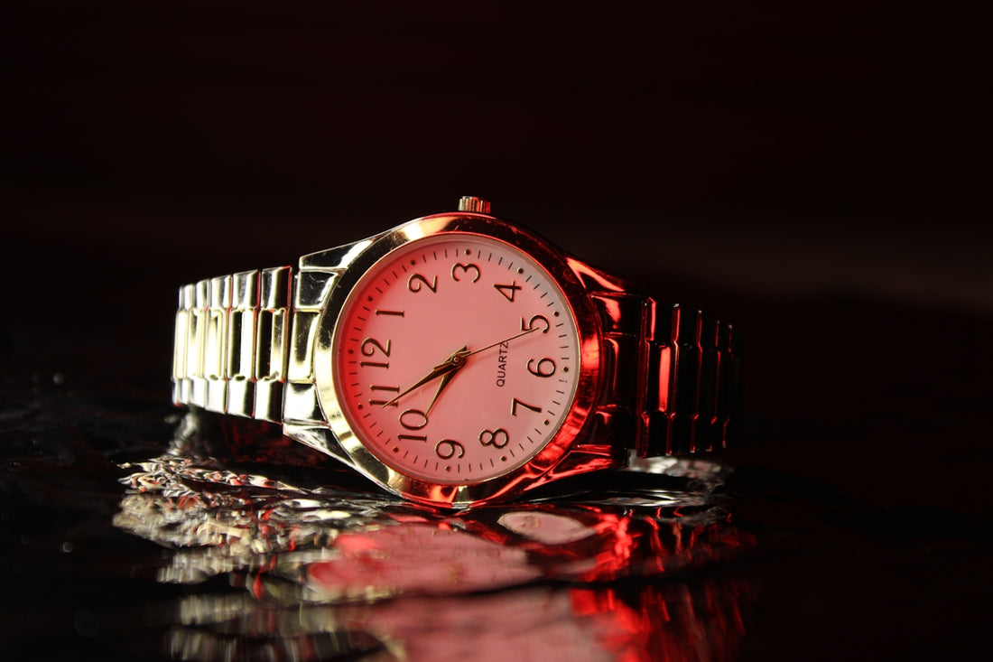 A red watch sitting on top of a table