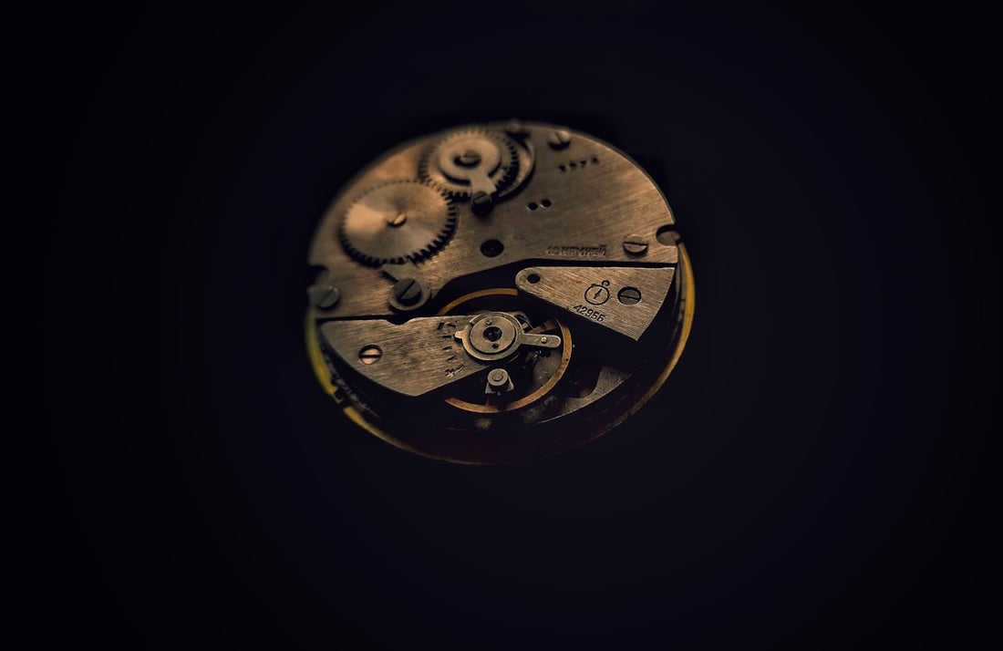 A close up of a clock face in the dark