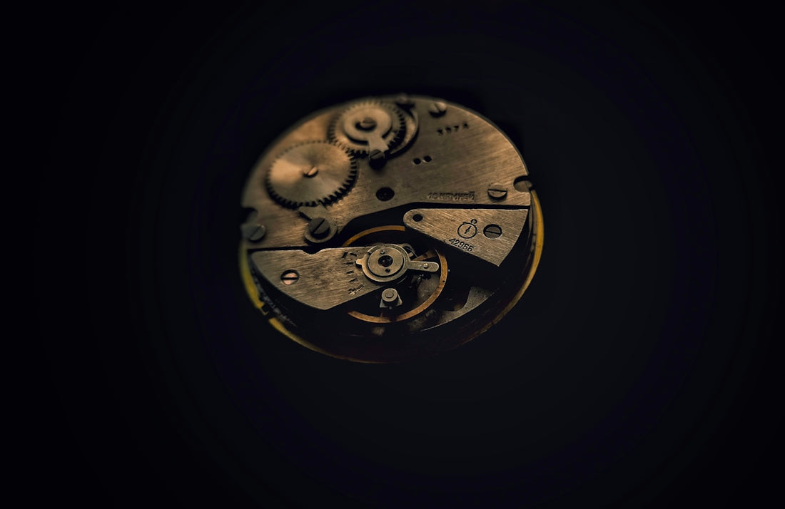 A close up of a clock face in the dark