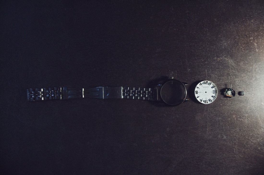A black and white photo of a watch on a table