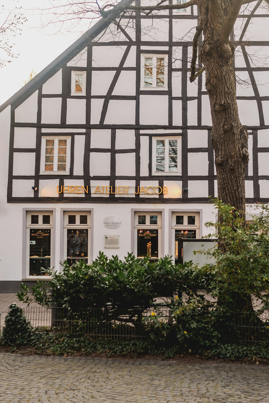 Historic half-timbered building with illuminated sign.